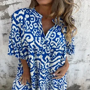 Detail view of blue and white geometric printed V-neck summer dress with pleated sleeves