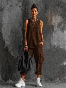 Full street style look with a brown sleeveless top, cargo pants, and white sneakers.