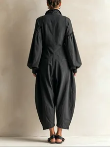 Back view of women's charcoal grey utility jumpsuit with puffy sleeves and curved legs