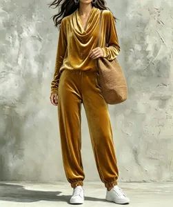 Detailed view of women's gold velvet tracksuit with cowl neck top and jogger pants