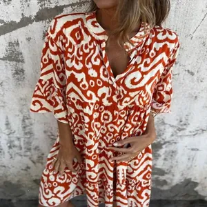 Detail view of casual V-neck printed pleated dress with bohemian orange patterns