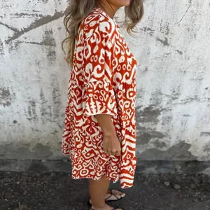 Detailed side view of a red and white patterned summer pleated casual dress