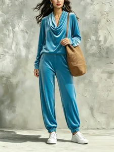 Elegant blue velour two-piece lounge set with cowl neck top and matching jogger pants