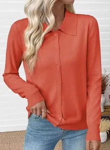 Close-up detail of a terracotta knit cardigan featuring a lapel collar and buttons.