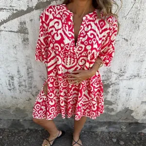 Detailed macro shot of the red and white geometric printed V-neck casual pleated mini dress