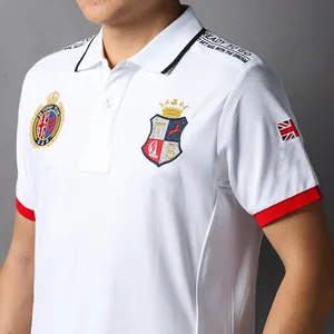 Detail view of men's white cotton Polo shirt with British style embroidery and badges.