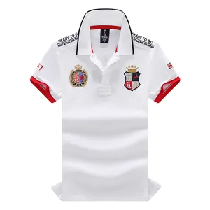 Detailed view of white men's British style polo shirt with red accents and embroidered patches