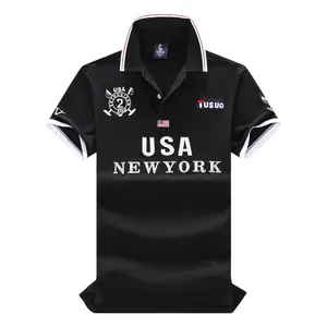 Detail view of the embroidered "USA NEW YORK" logo on a black cotton Polo shirt.