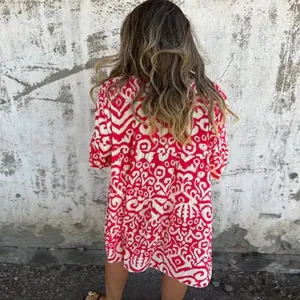 Detailed back view of a casual red and white bohemian print pleated summer dress
