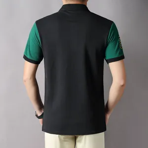 Back view of British style men's sports polo shirt with green and black color block