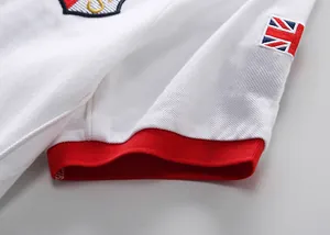Close-up of white cotton Polo shirt with British flag embroidery and red cuff