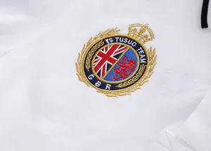 Macro view of detailed British crest embroidery on a white cotton piqué polo shirt