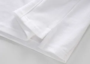 Macro view of white piqué cotton Polo shirt side slit and reinforced hem stitching