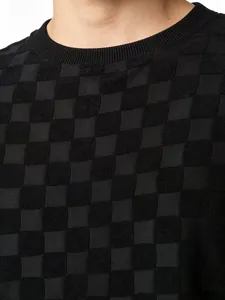 Gros plan du gilet en maille jacquard noir pour homme montrant la texture du tissu.