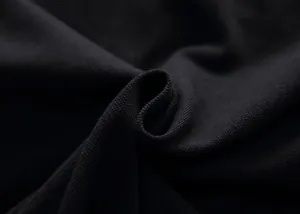 Macro close-up detail of black breathable cotton piqué fabric texture on Polo shirt