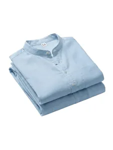 Close-up detail of a folded light blue linen Henley shirt showing collar and size tag