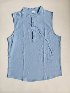 Close-up view of light blue sleeveless linen Henley shirt with buttoned chest pocket detail