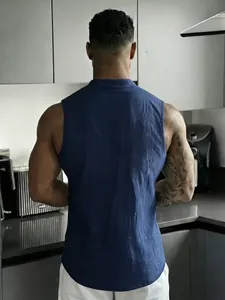 Back view of men's casual navy blue linen sleeveless Henley vest in a kitchen setting