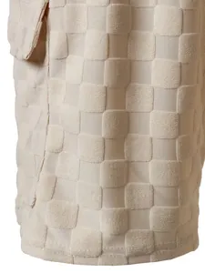 Detailed view showing the cream textured checkered jacquard fabric on men's summer vacation shorts