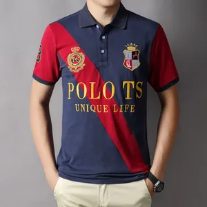 Close-up of men's polo shirt featuring diagonal color-blocking and embroidered crests.
