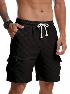 Detailed view of men's casual black shorts with checkered jacquard texture and drawstring.