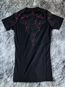Detailed back view of black sports compression T-shirt with red gothic graphic print detail.
