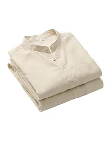Detailed close-up of a neatly folded cream linen-blend Henley shirt with buttons