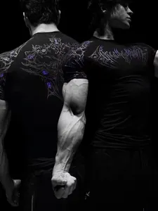 Detail shot of men's compression shirt showing stylized purple print and muscle fit.