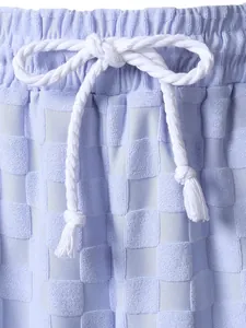 Detailed macro view of men's lavender checkerboard jacquard shorts with white rope drawstring