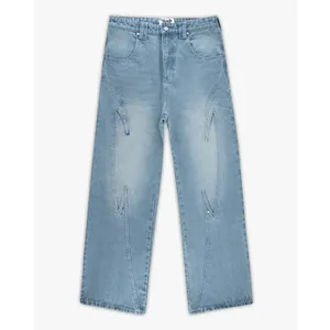 Detail of light wash wide leg jeans featuring unique artistic embroidered patterns.