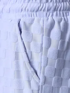 Close-up of lavender checkered jacquard fabric texture on men's casual shorts