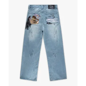 Detailed view of the artistic embroidered fallen angel motif on light wash straight jeans