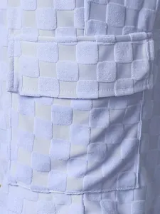 Macro view of men's lilac checkerboard jacquard fabric shorts detailing pocket structure