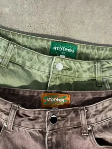 Detailed view of 4TOTHE9 washed gradient denim jeans in matcha green and brown colors