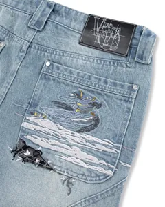 Close-up view of the artistic fallen angel embroidery on washed denim jeans back pocket