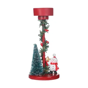 Festive Christmas candle holder with a snowman figure and miniature tree decoration