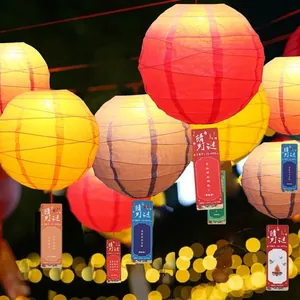 Traditional colorful Chinese New Year paper lanterns decorated with hanging riddle cards