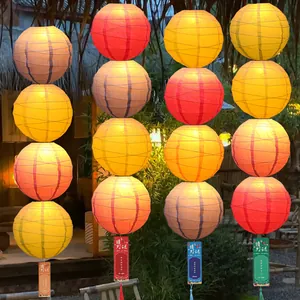Traditional macaron colored paper lanterns with riddle cards for festive New Year decor