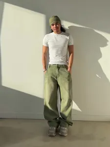 Stylish matcha green wide-leg jeans with washed gradient effect shown on a male model