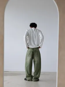Back view of relaxed matcha green wide-leg denim pants with washed gradient detail
