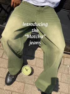 Close-up showing loose-fitting matcha green washed gradient denim wide-leg jeans