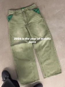 Macro view of matcha green wide-leg jeans featuring a washed vintage texture and pockets