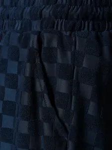 Macro view of checkered jacquard texture on men's navy blue casual vacation shorts