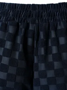 Macro detail of navy blue checkerboard jacquard terry cloth fabric on casual men shorts