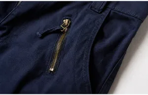 Detailed macro view of side slanted pocket with zipper and reinforced stitching on navy cargo pants
