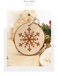Detailed close-up of natural wood slice ornament with engraved snowflake design