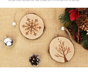 Detailed view of natural wood slice Christmas ornaments with snowflake and tree engravings