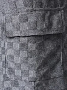 Detailed view of grey checkerboard jacquard texture on men's fashion casual summer shorts pocket
