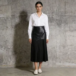 Falda midi plisada asimétrica de cuero sintético de cintura alta para mujer estilo urbano