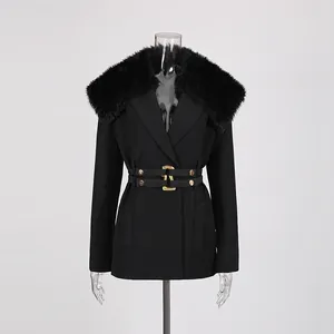 Detailed shot of black blazer with detachable fur collar and double buckle belt.
